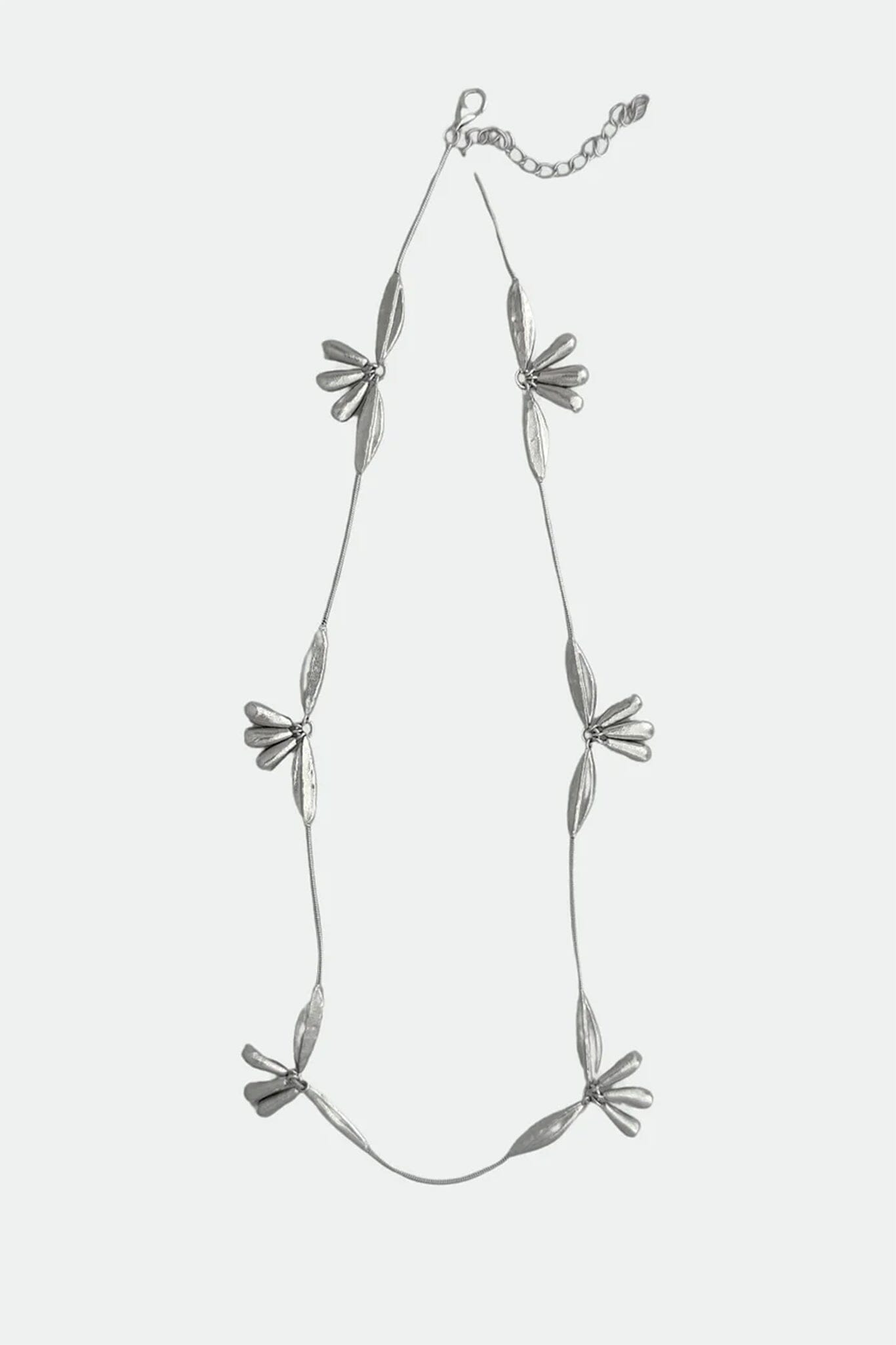 Silver necklace with floral pendants on a white background