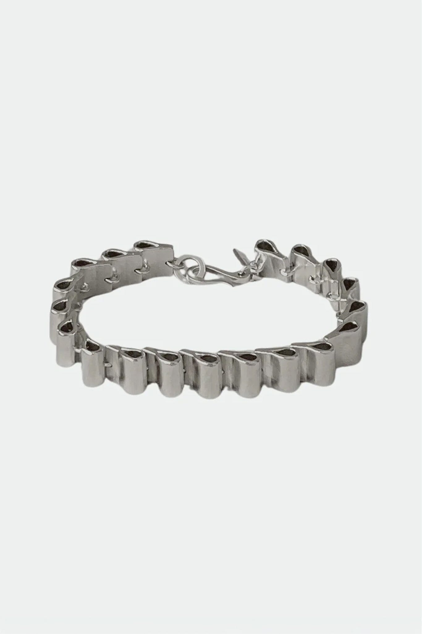 Silver structural bracelet on a white background