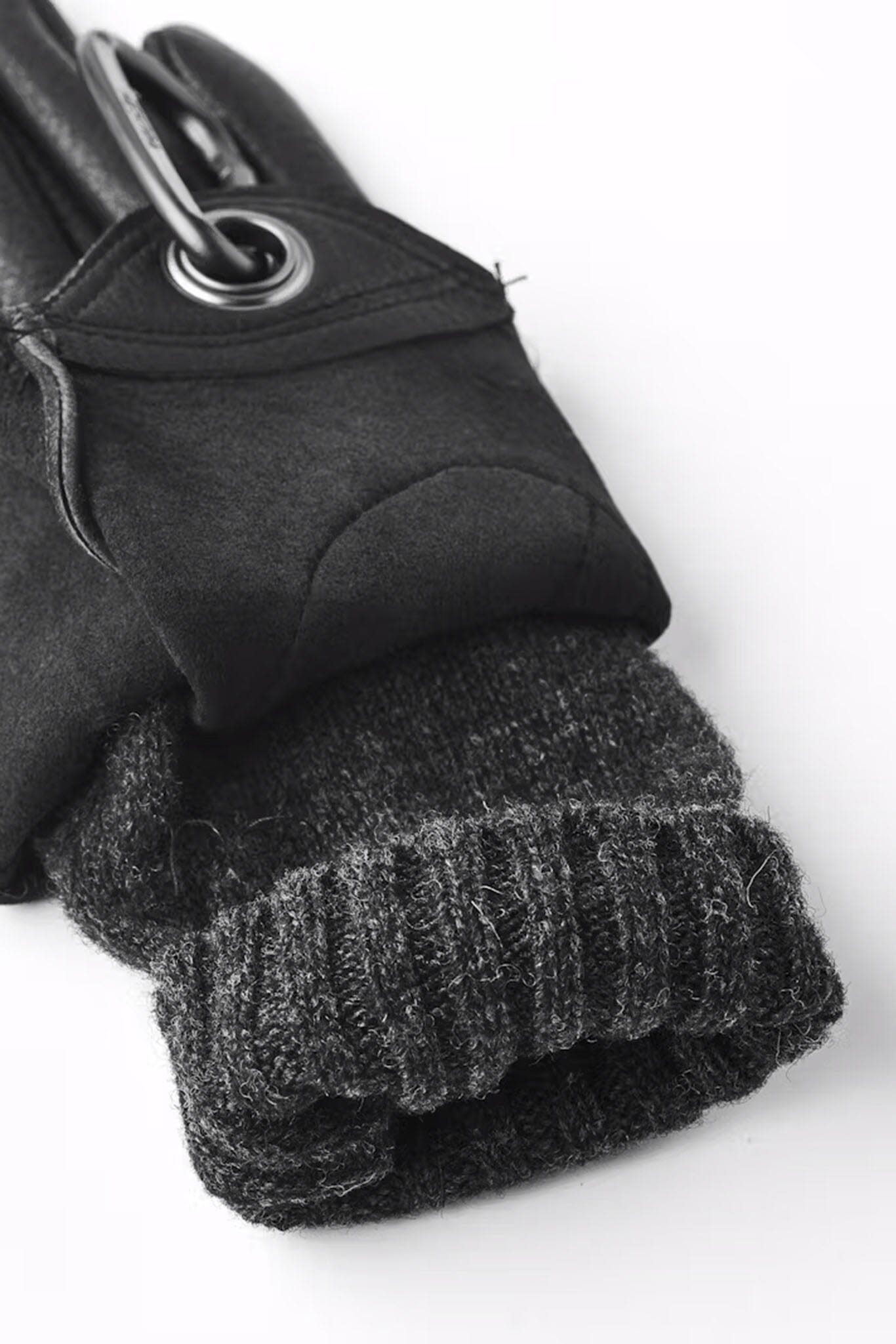 A detailed shot of the wool lining of a women's black leather glove