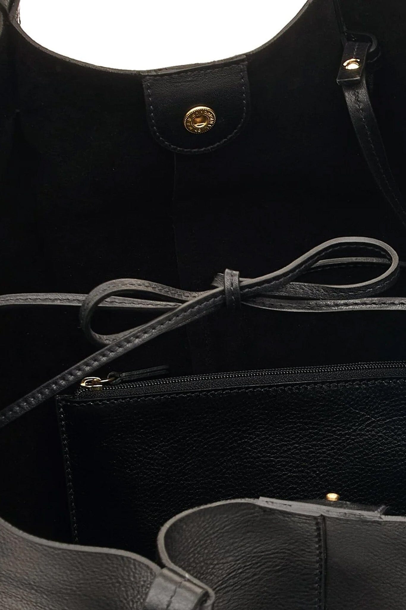 Close-up of a black leather bag with a drawstring and gold accents.