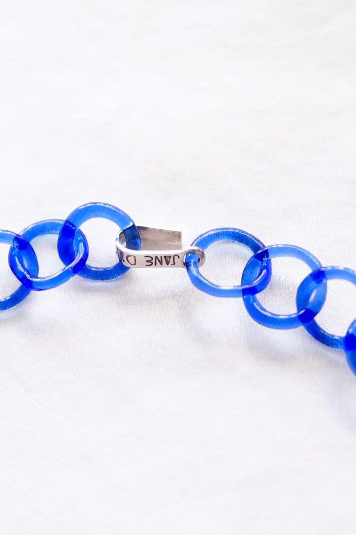 The silver clasp on a glass circle chain link