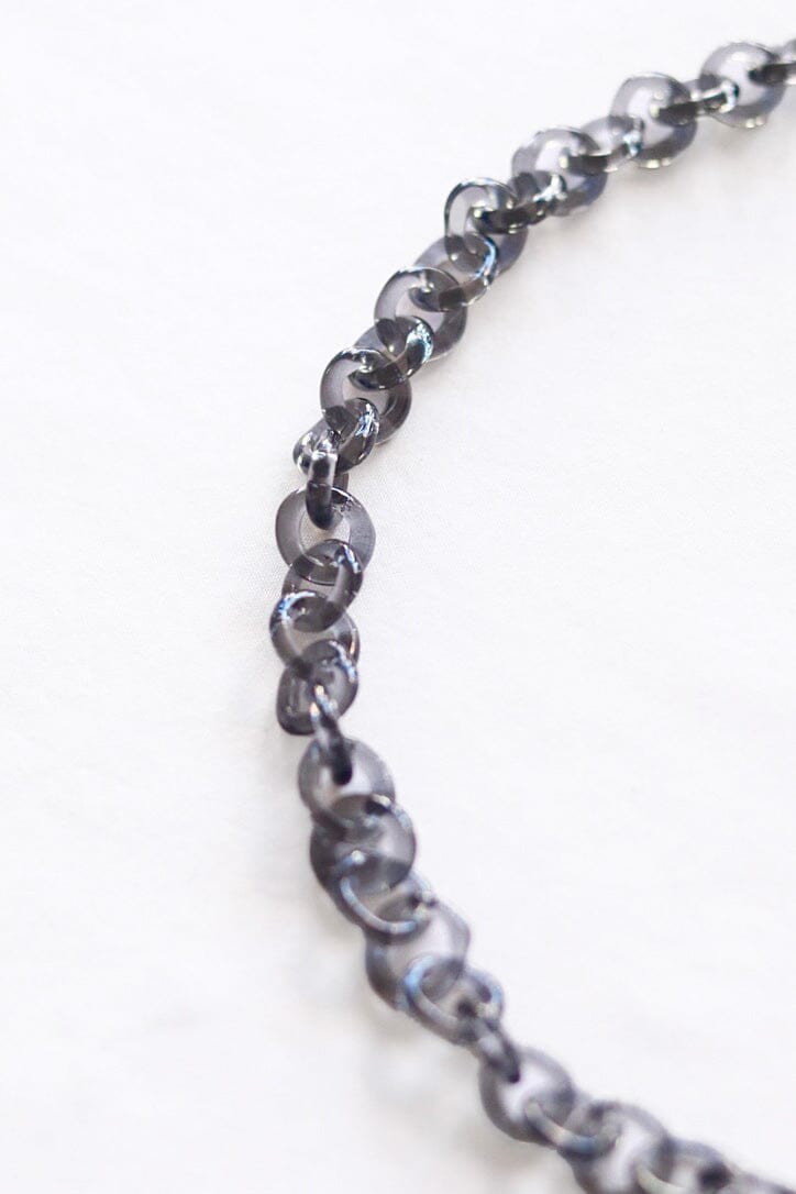 A close up of a grey glass link chain
