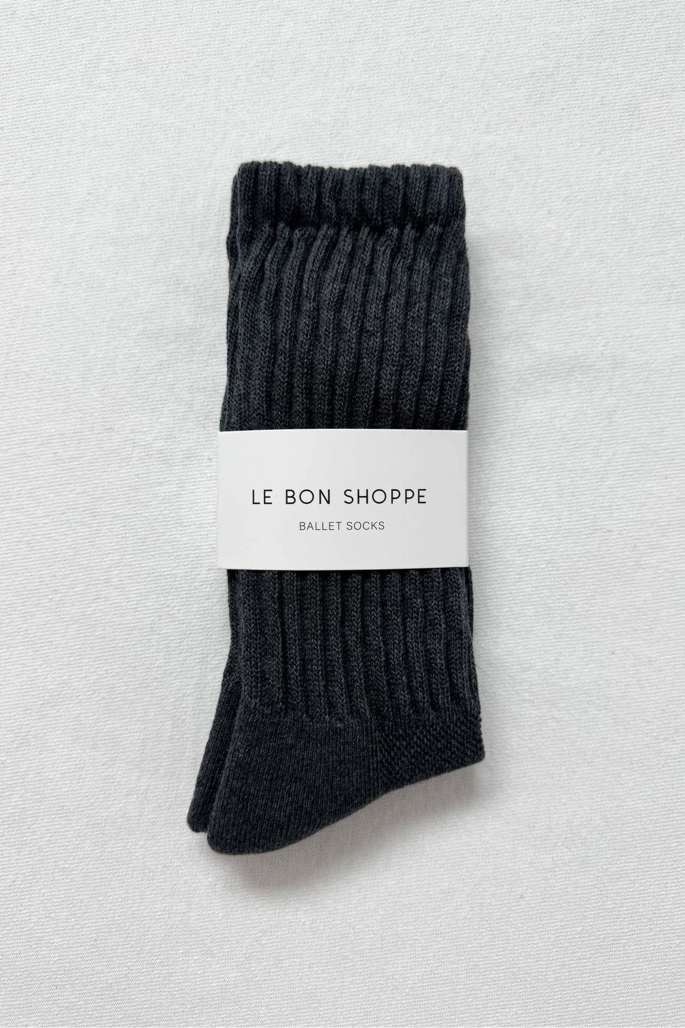 Dark gray ballet socks with a white label on a light gray background