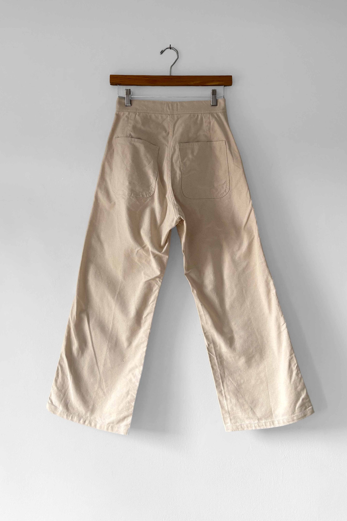 The back view of beige wide leg high waisted pants