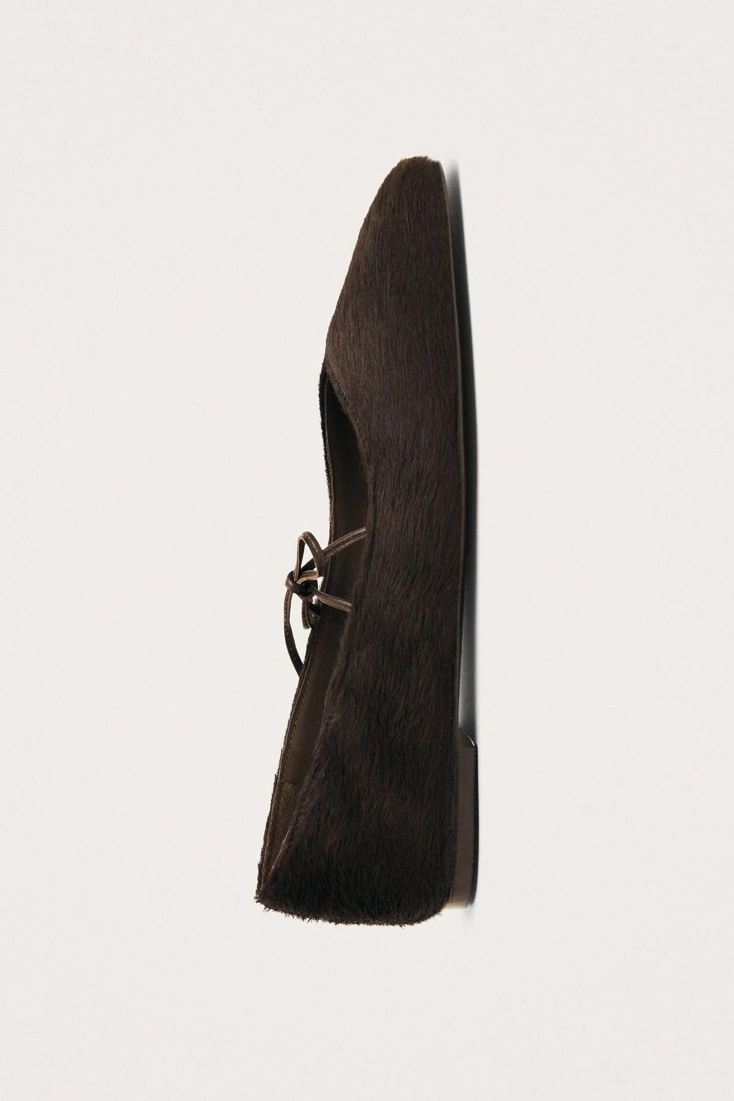 Side vivew of dark brown calf hair square toe women's flats