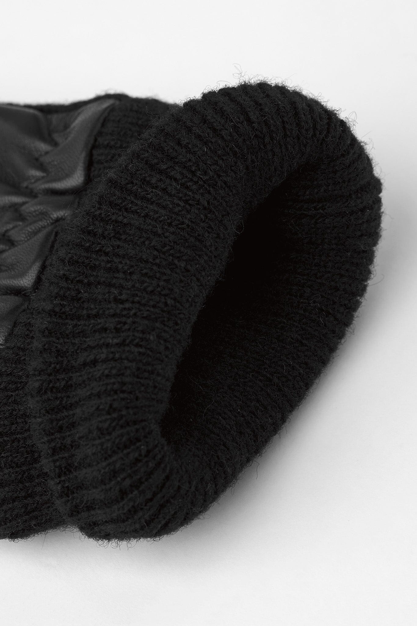 The inside lining of a black wool glove