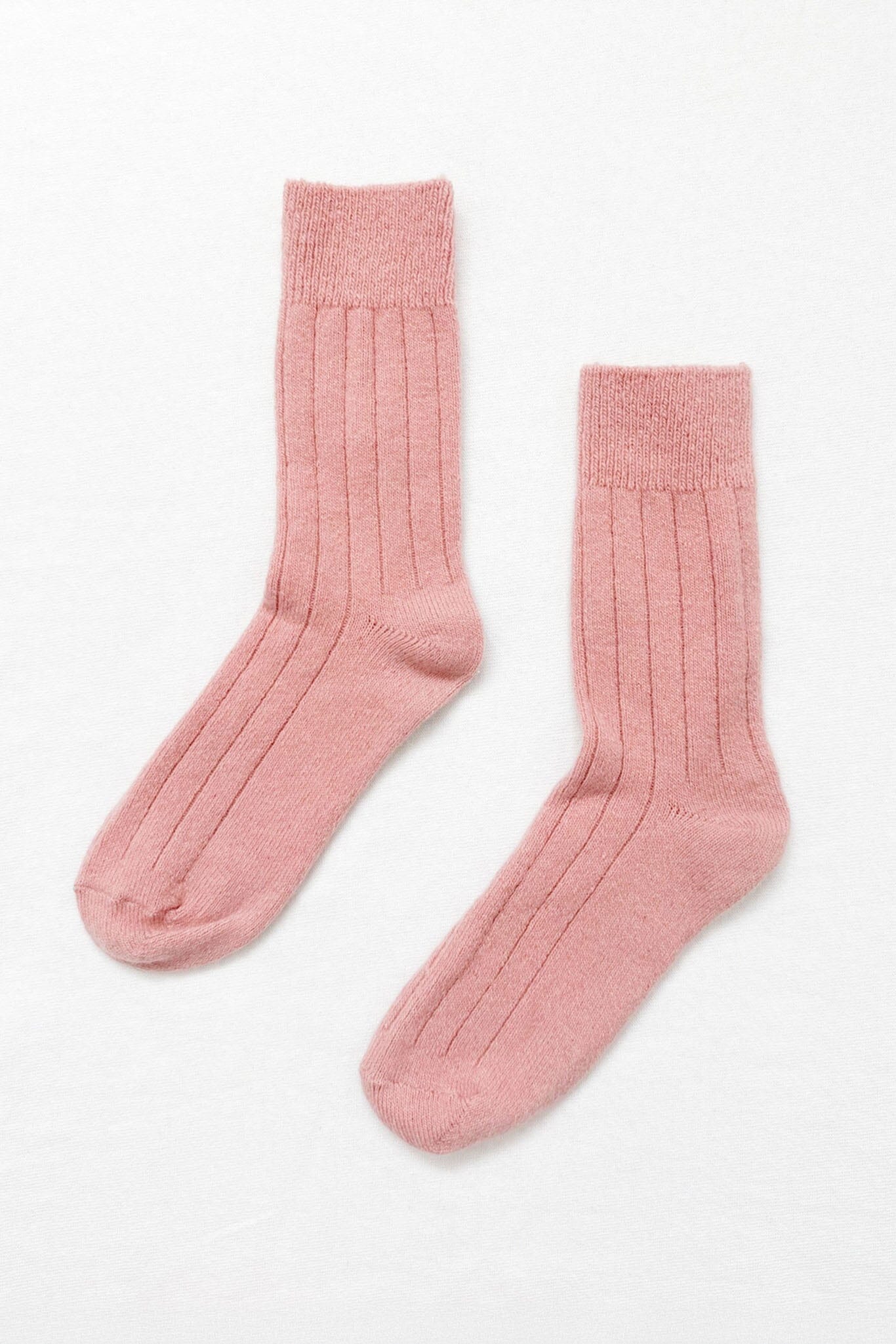 A pair of pink, cashmere-blend socks with wide ribbing, contrasting heel and toe, on a white background.