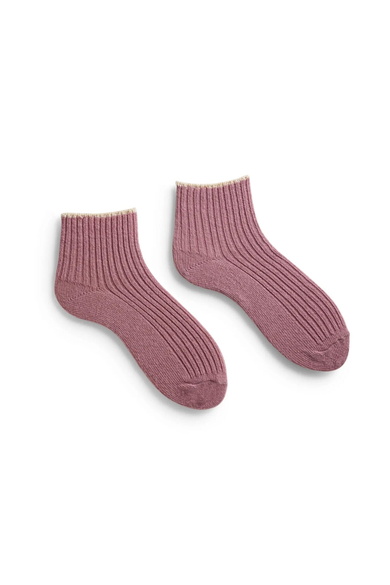 A pair of pink ribbed cashmere shortie socks against a white background.