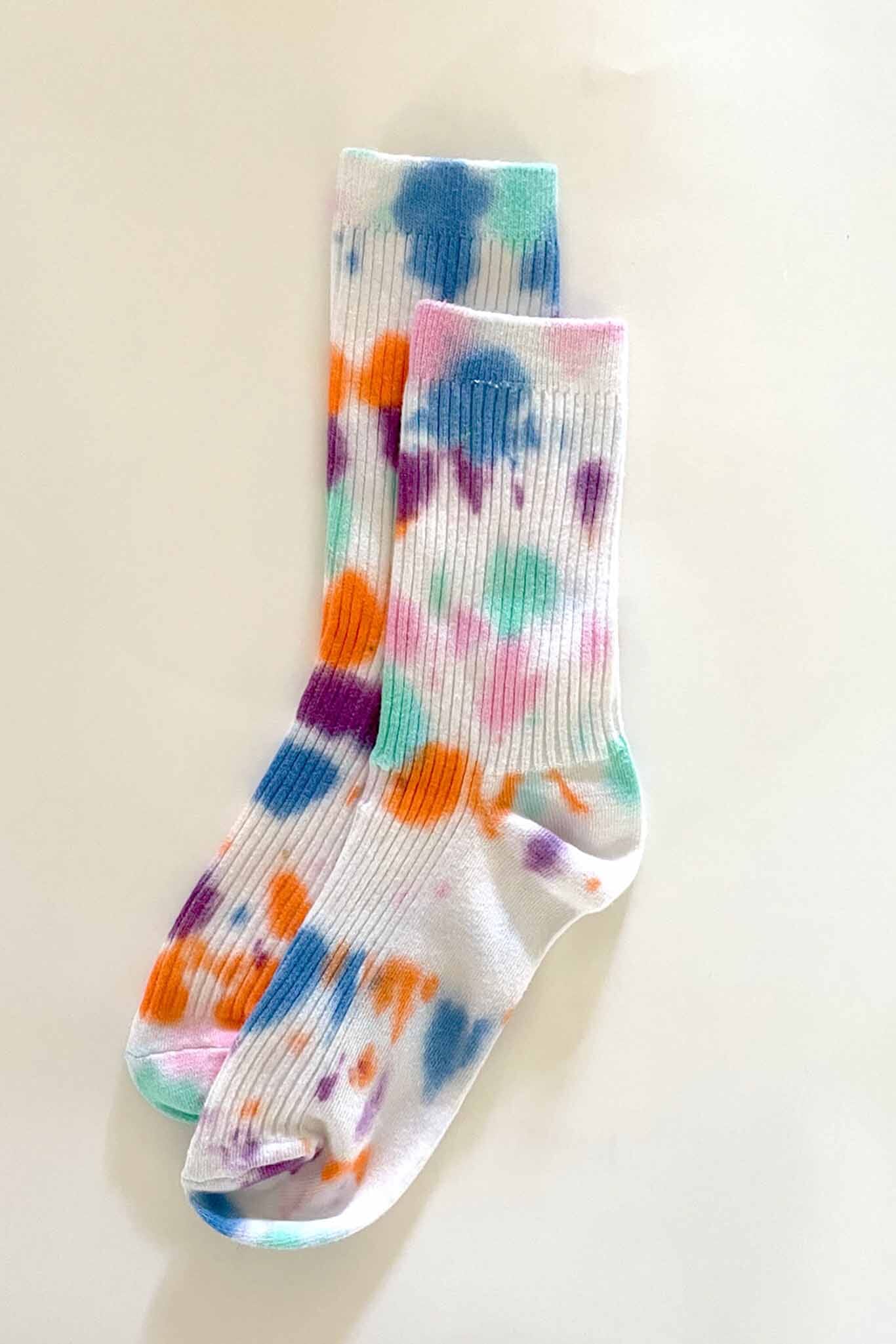 A pair of tie-dye cotton socks with multiple colors including white, pink, blue, and orange.