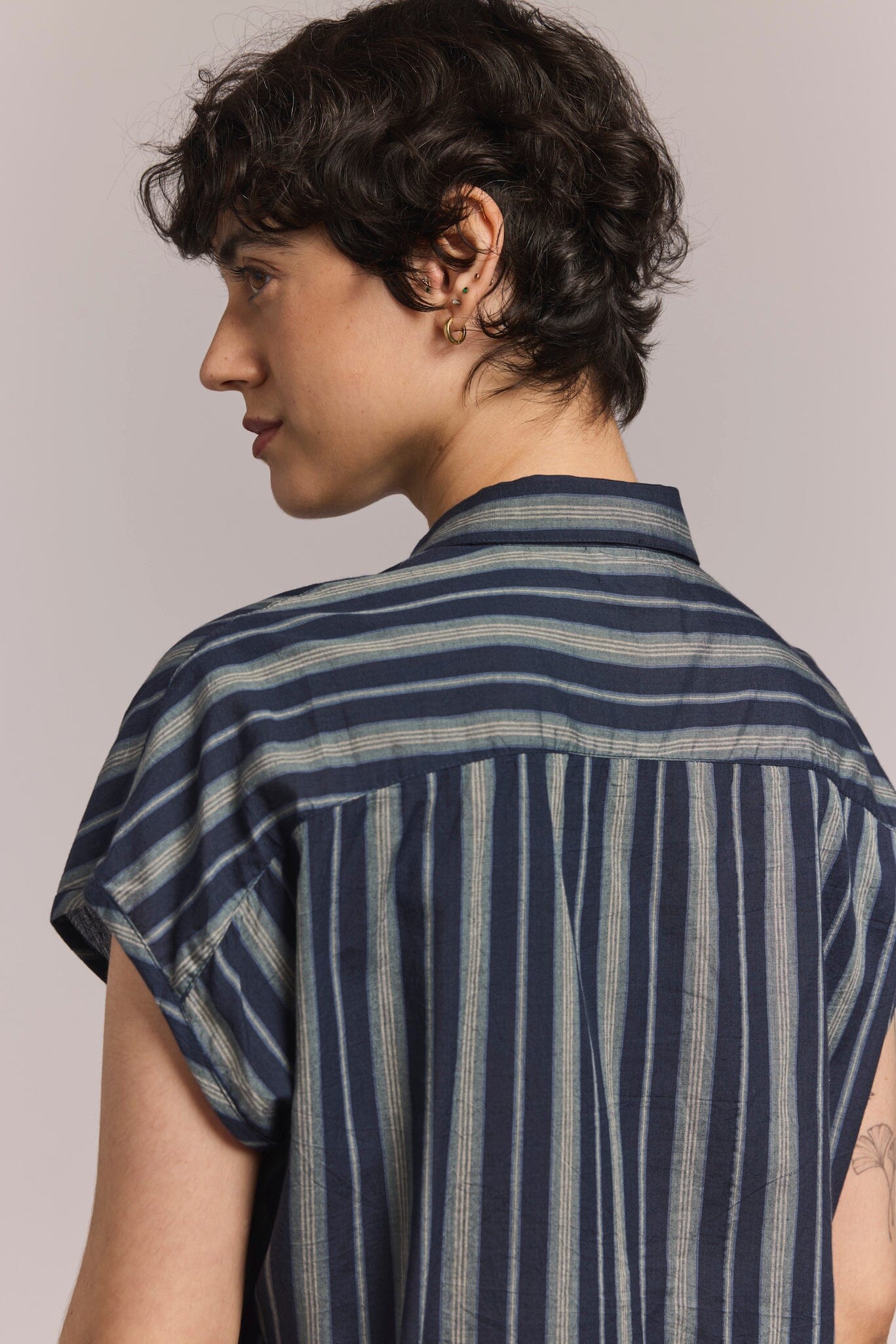 back view of model with a sleeveless collared top