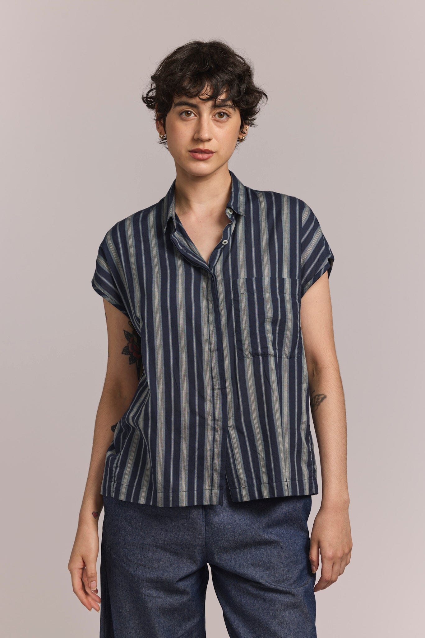 model wearing a collared button down shirt with short sleeves