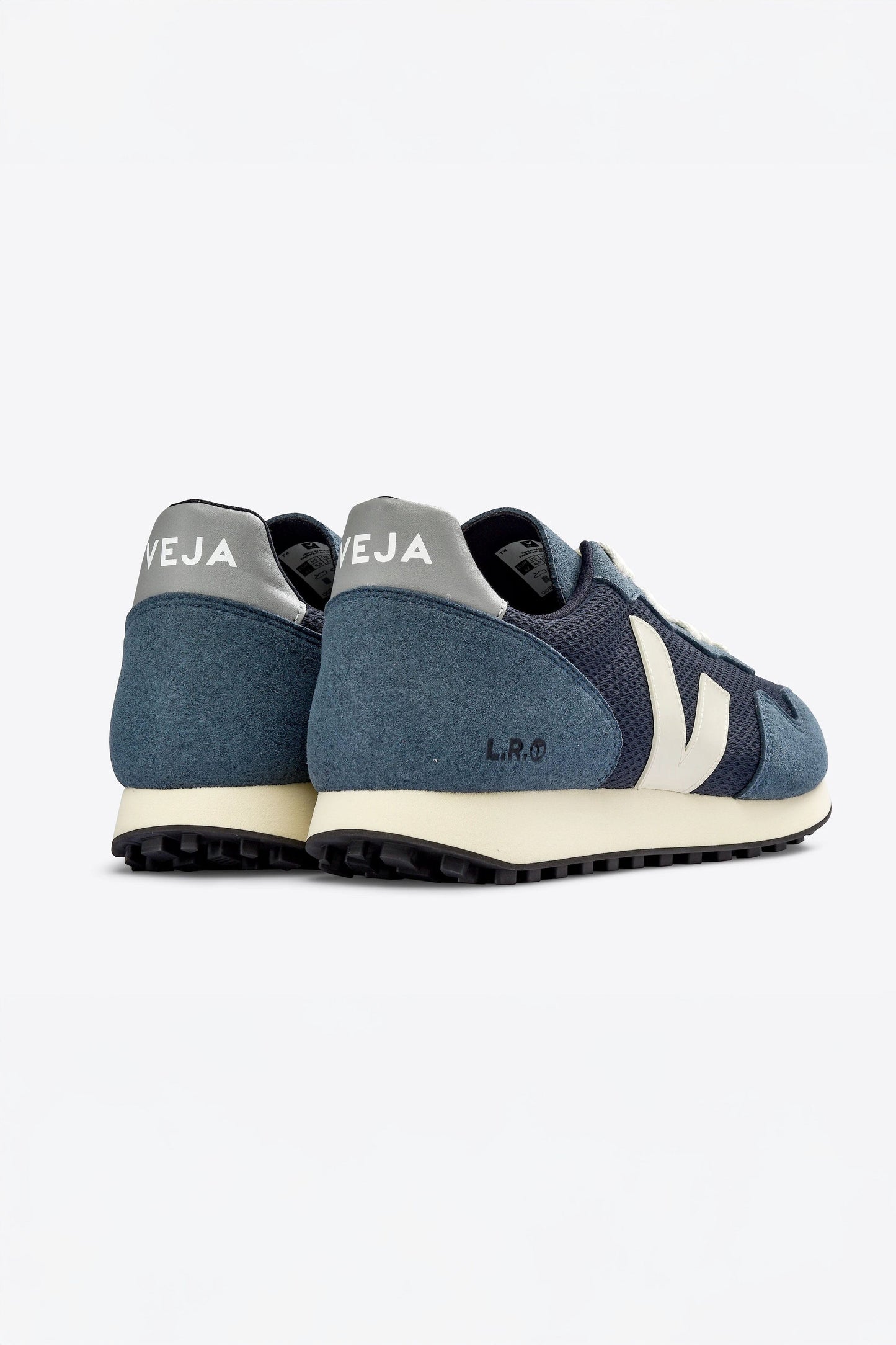 The back view of blue and white Veja SDU Alveomesh sneakers with mesh paneling and a lace-up closure.