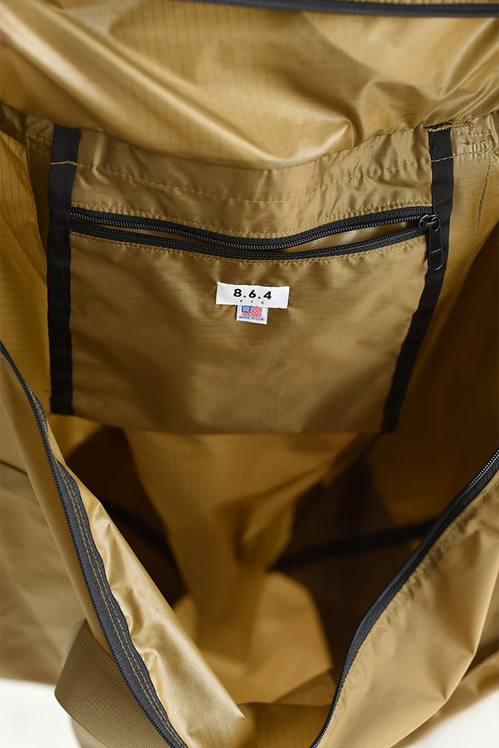 A close up of the interior of an 8.6.4. large weekender tote bag in light brown