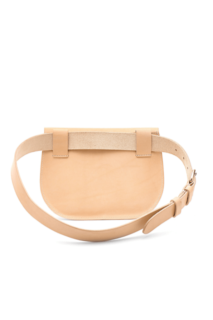 The back of a beige Il Bisonte belt pack made of cowhide leather, featuring an adjustable belt with a brass buckle.