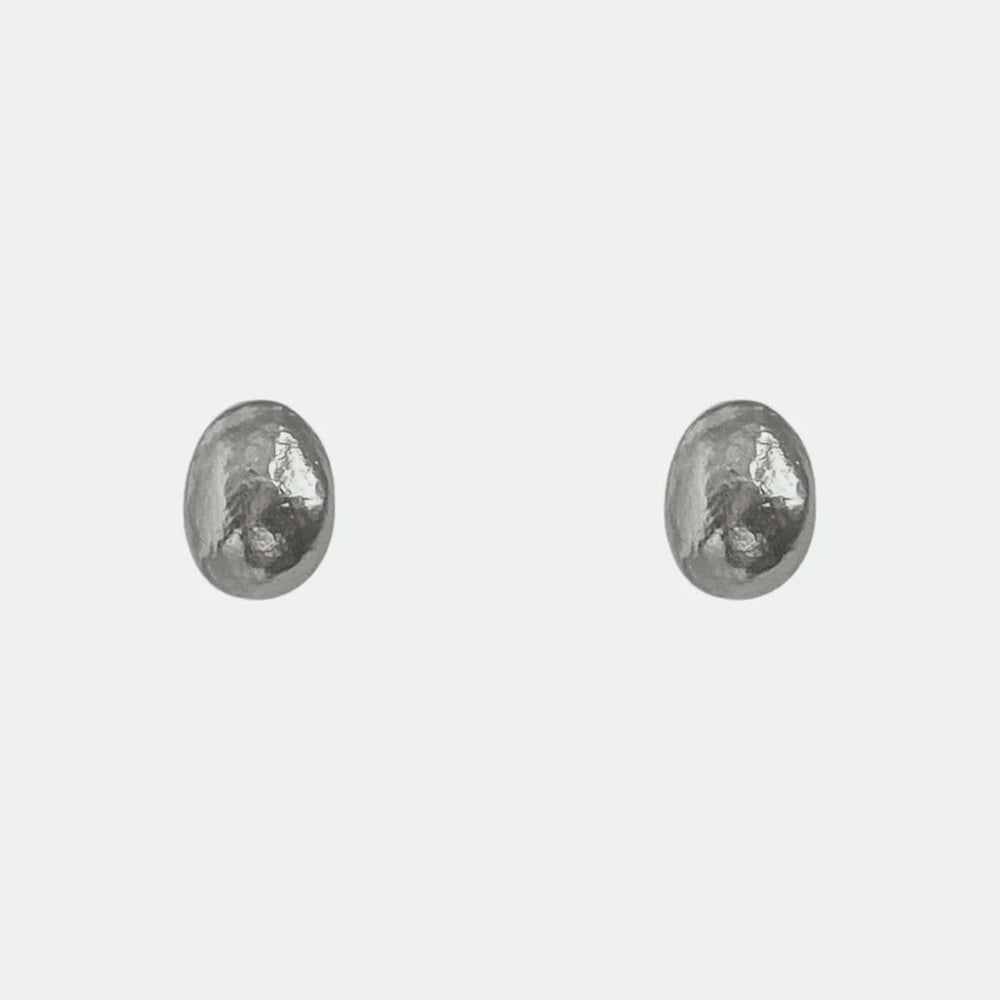 Pair of silver dome stud earrings on a white background