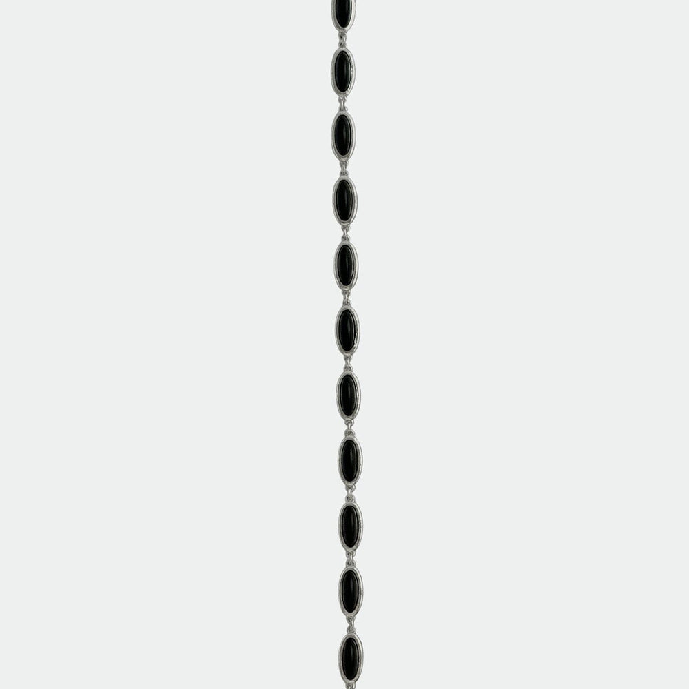 Black beaded bracelet with a hook closure on a white background