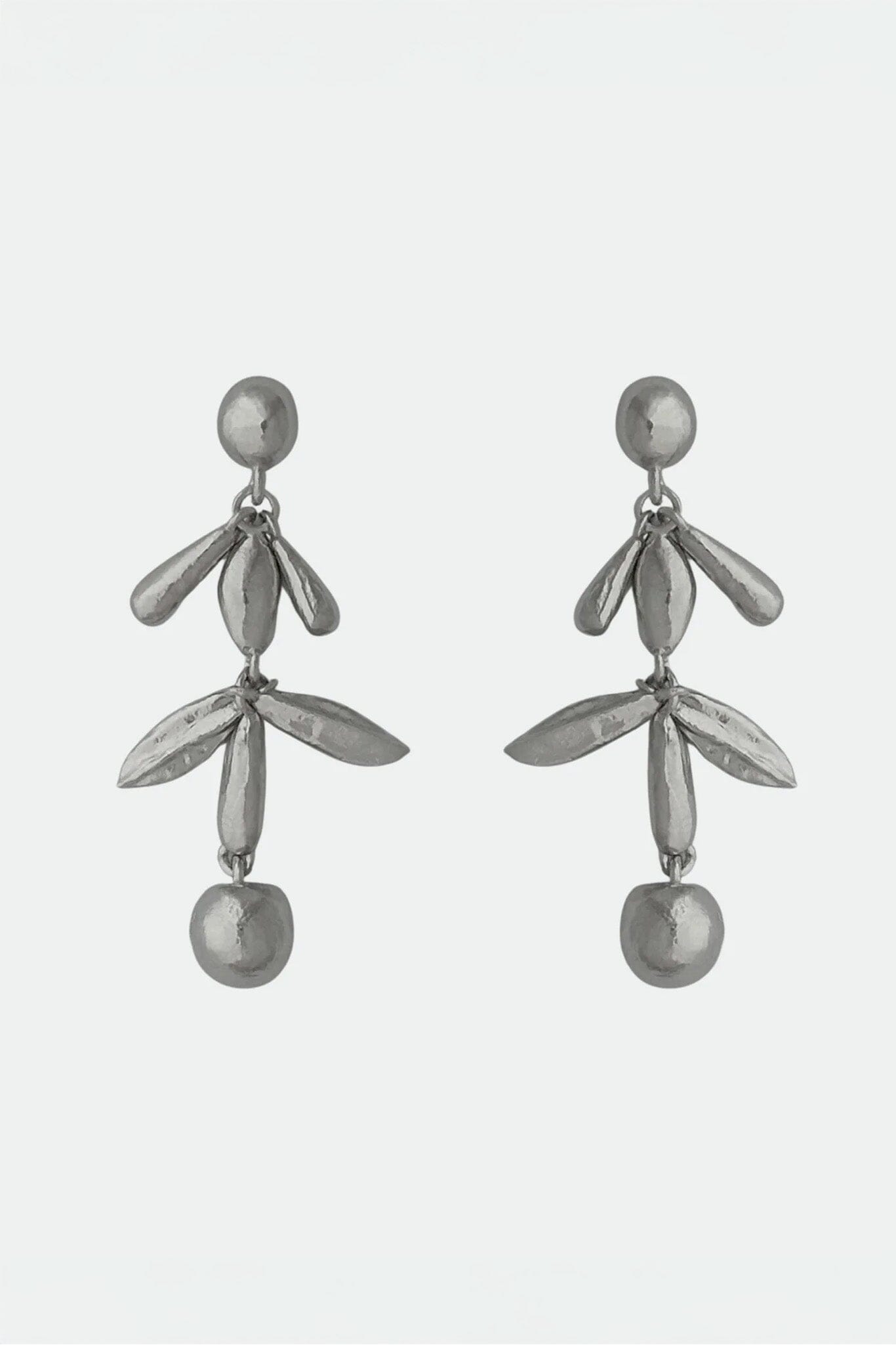 Pair of silver drop earrings with leaf-like designs on a white background