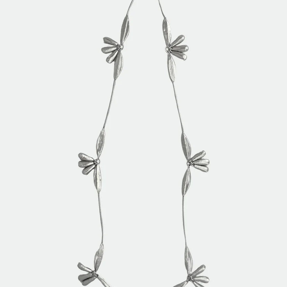 
                  
                    Silver necklace with floral pendants on a white background
                  
                