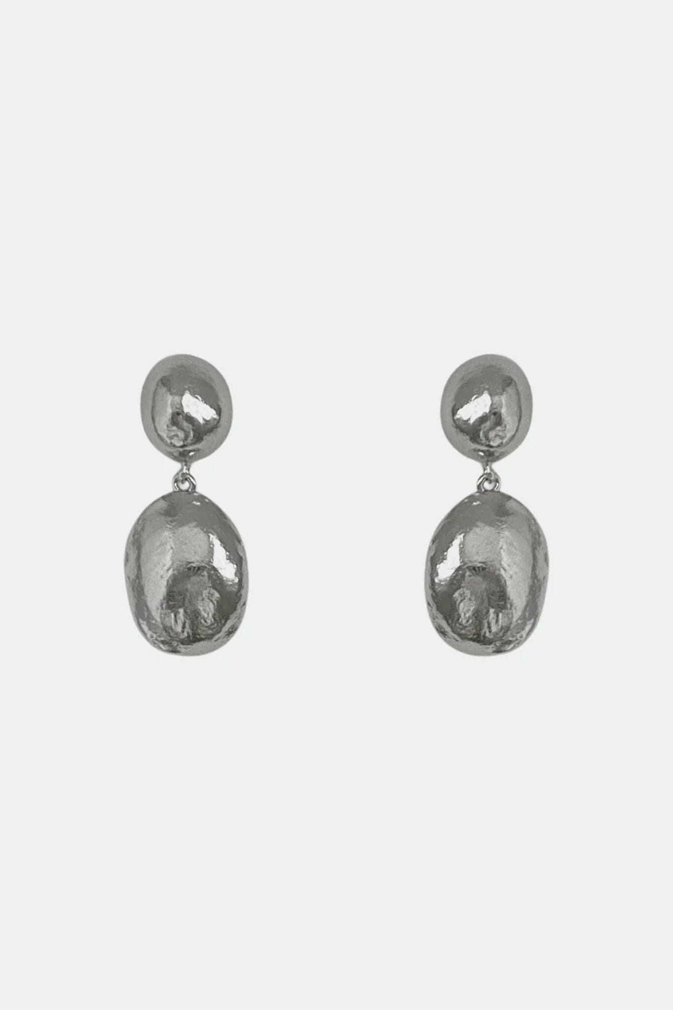 Pair of silver dome stud drop earrings on a light gray background