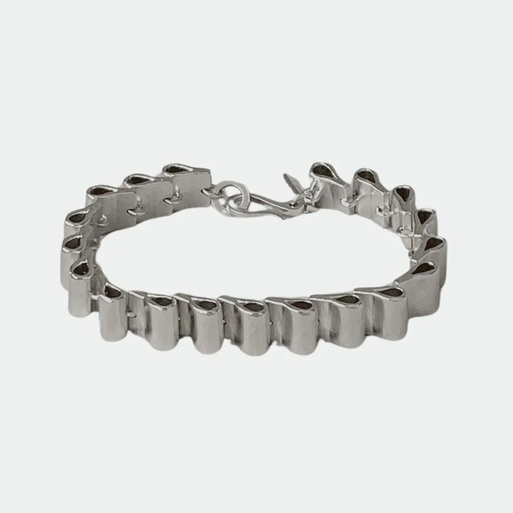 
                  
                    Silver structural bracelet on a white background
                  
                