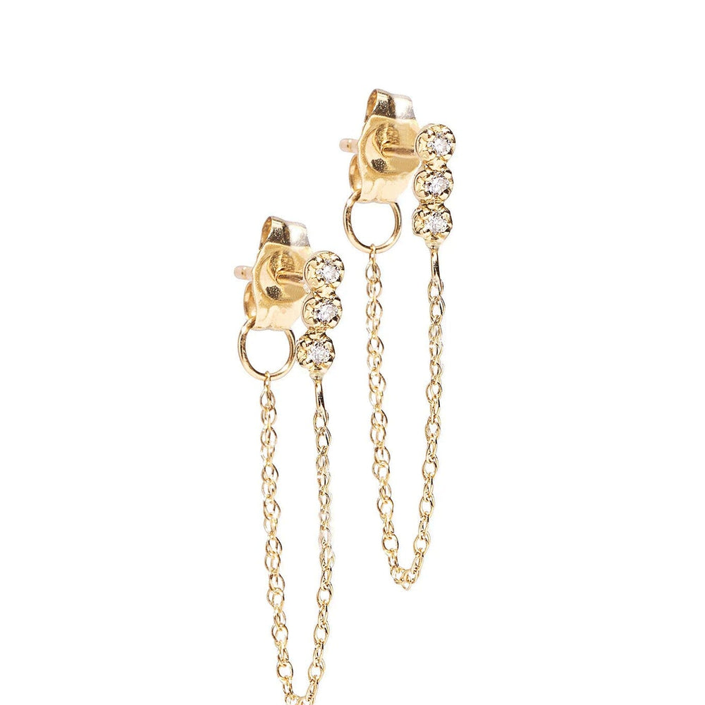 Gold earrings with chain details on a white background