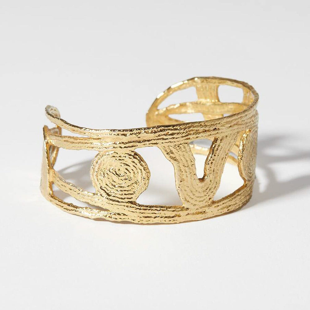 
                  
                    Textured, gold plated noturne wrap bracelet by COG. Available to purchase at M.Patmos Brooklyn. 
                  
                