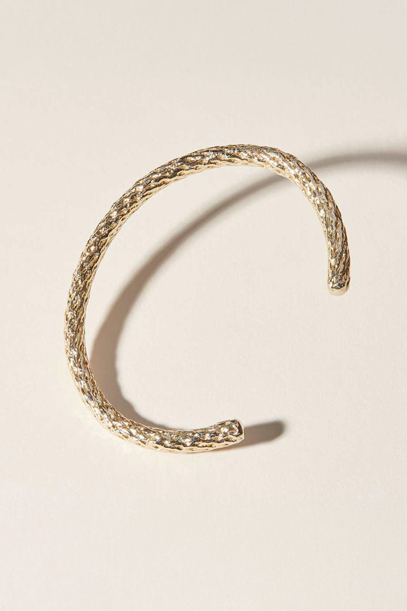 Cog gold splice cuff bracelet at M.Patmos in Brooklyn.