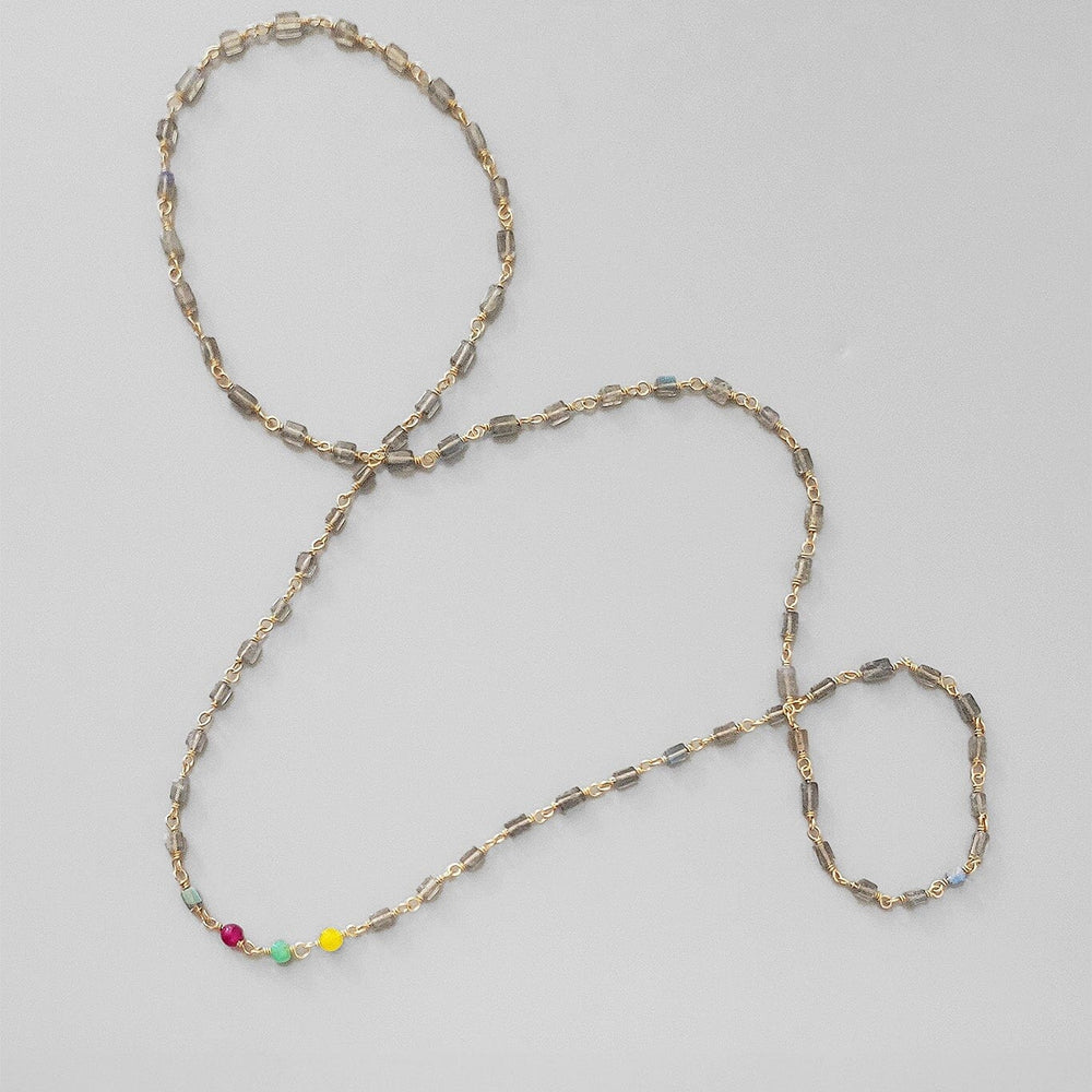 
                  
                    Necklace with multicolored beads on a light gray background
                  
                