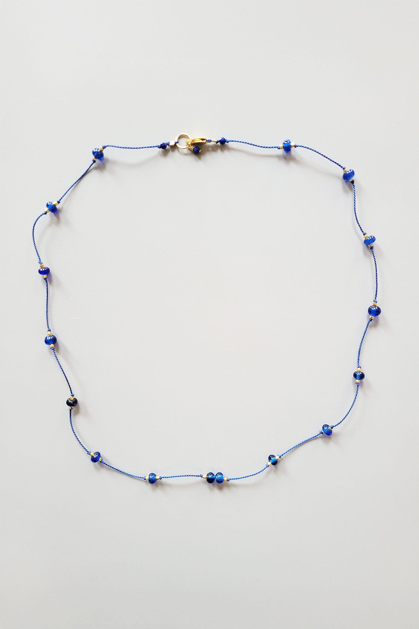 Necklace with blue beads on a white background
