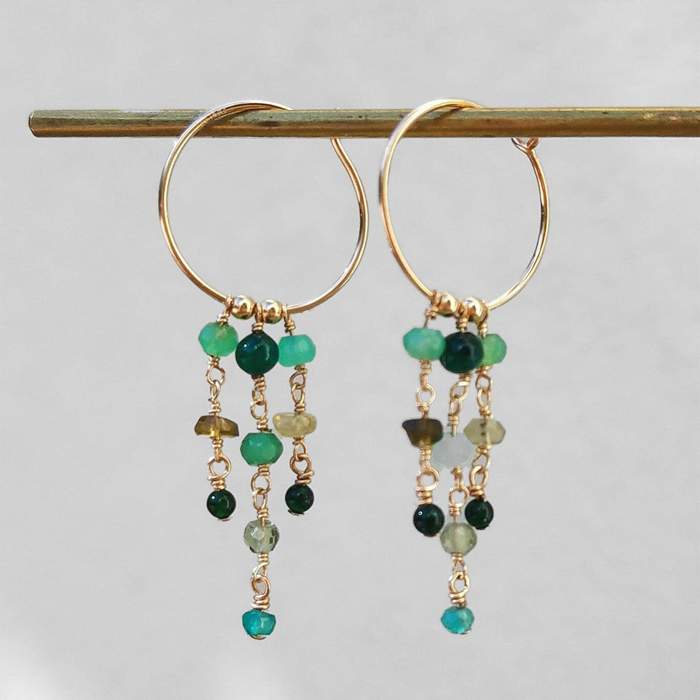 14k gold filled hoops featuring strands of green gemstones such as adventurine and apatite. Available at M.Patmos in Brooklyn New York.