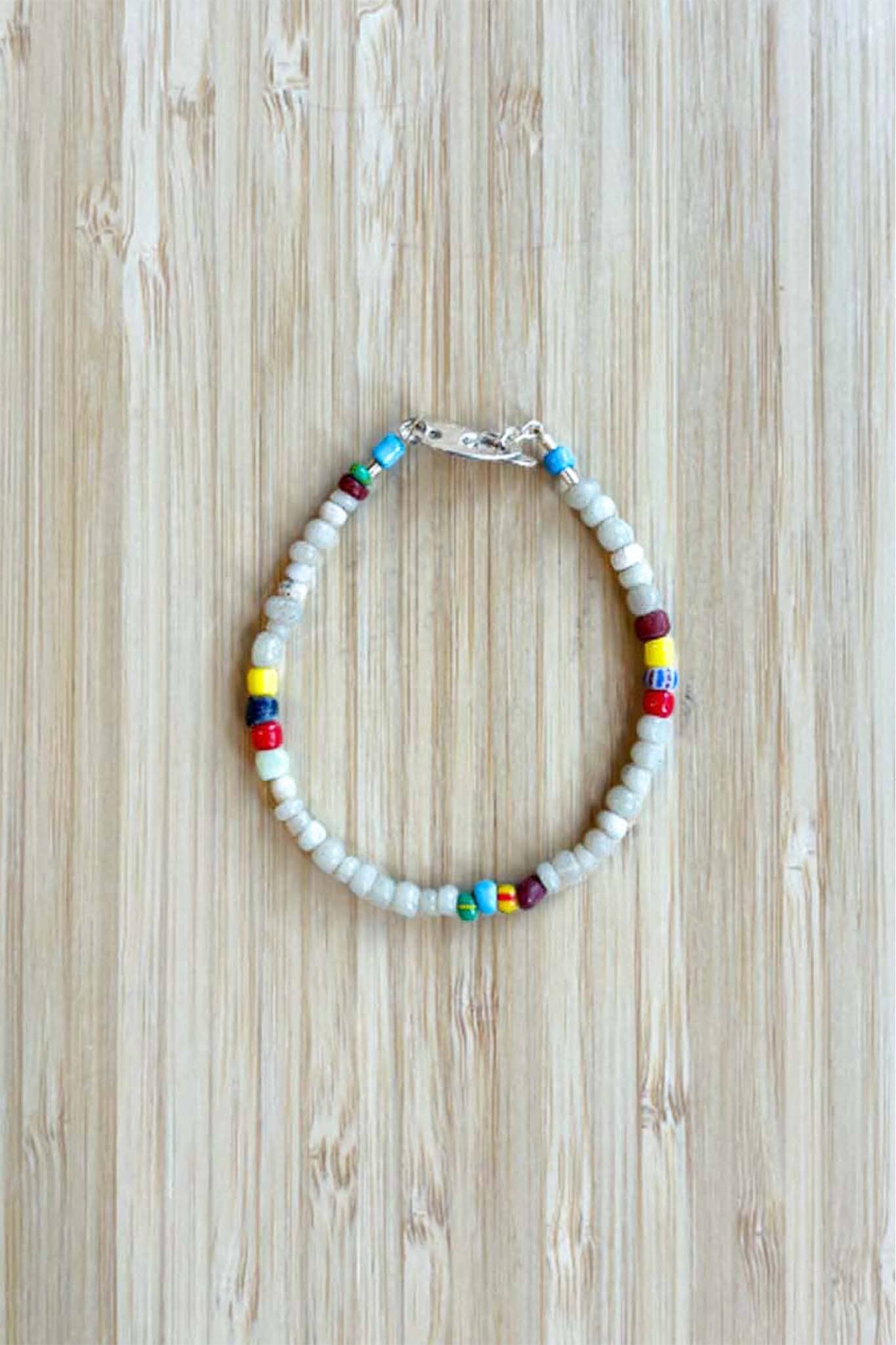 A white and multi-color beaded bracelet with a silver clasp