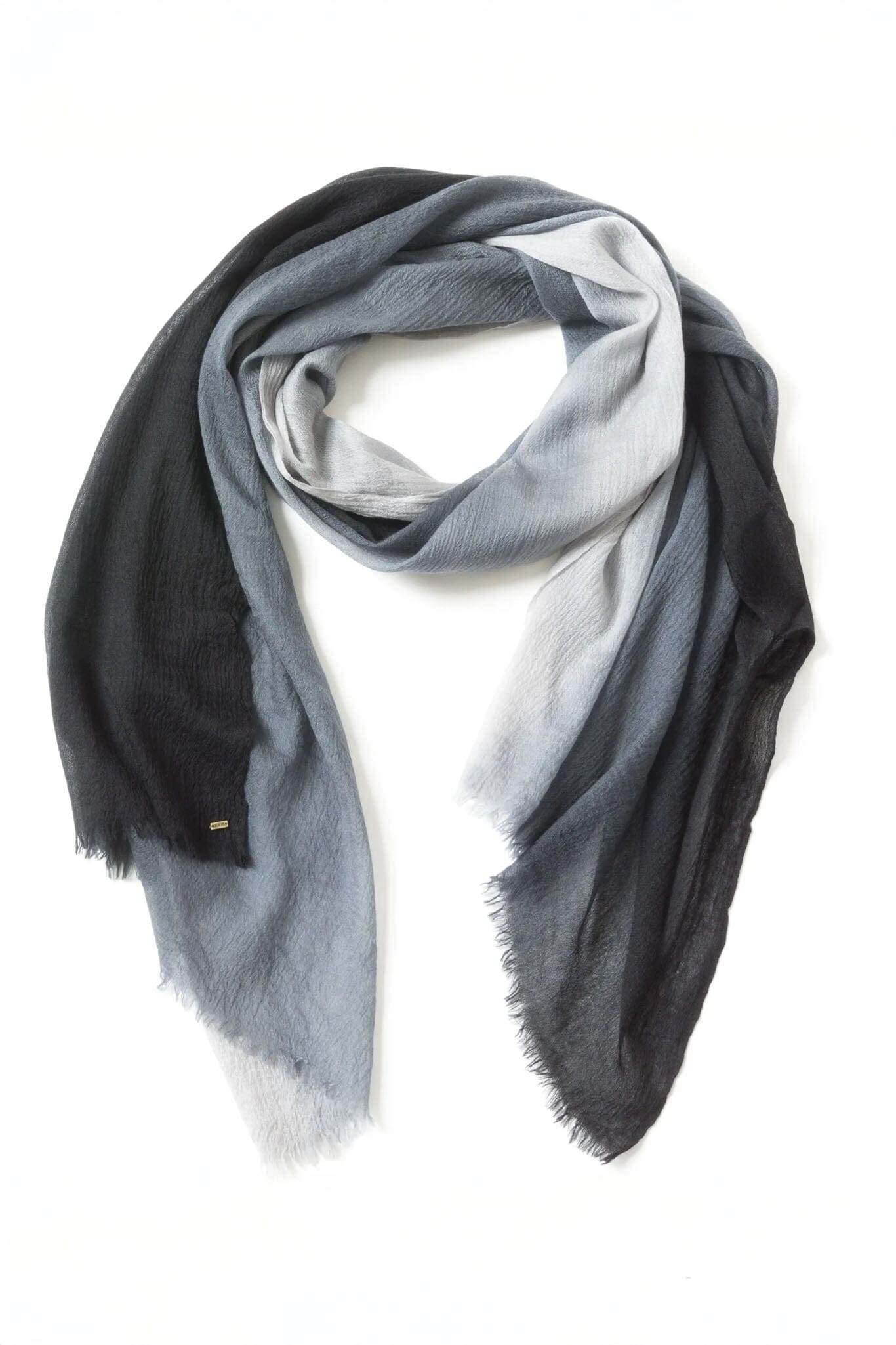 Gradient cashmere scarf transitioning from black to gray on a white background