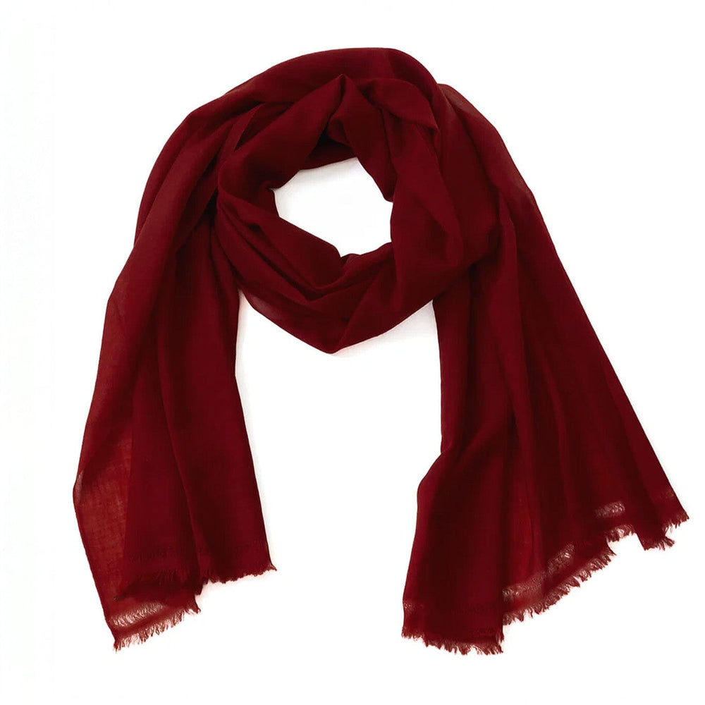 Dark red merino wool scarf on a white background