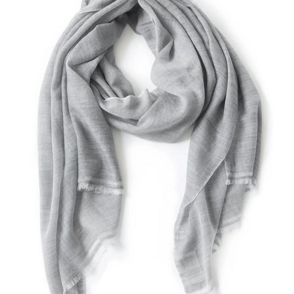 A light gray merino wool scarf on a white background