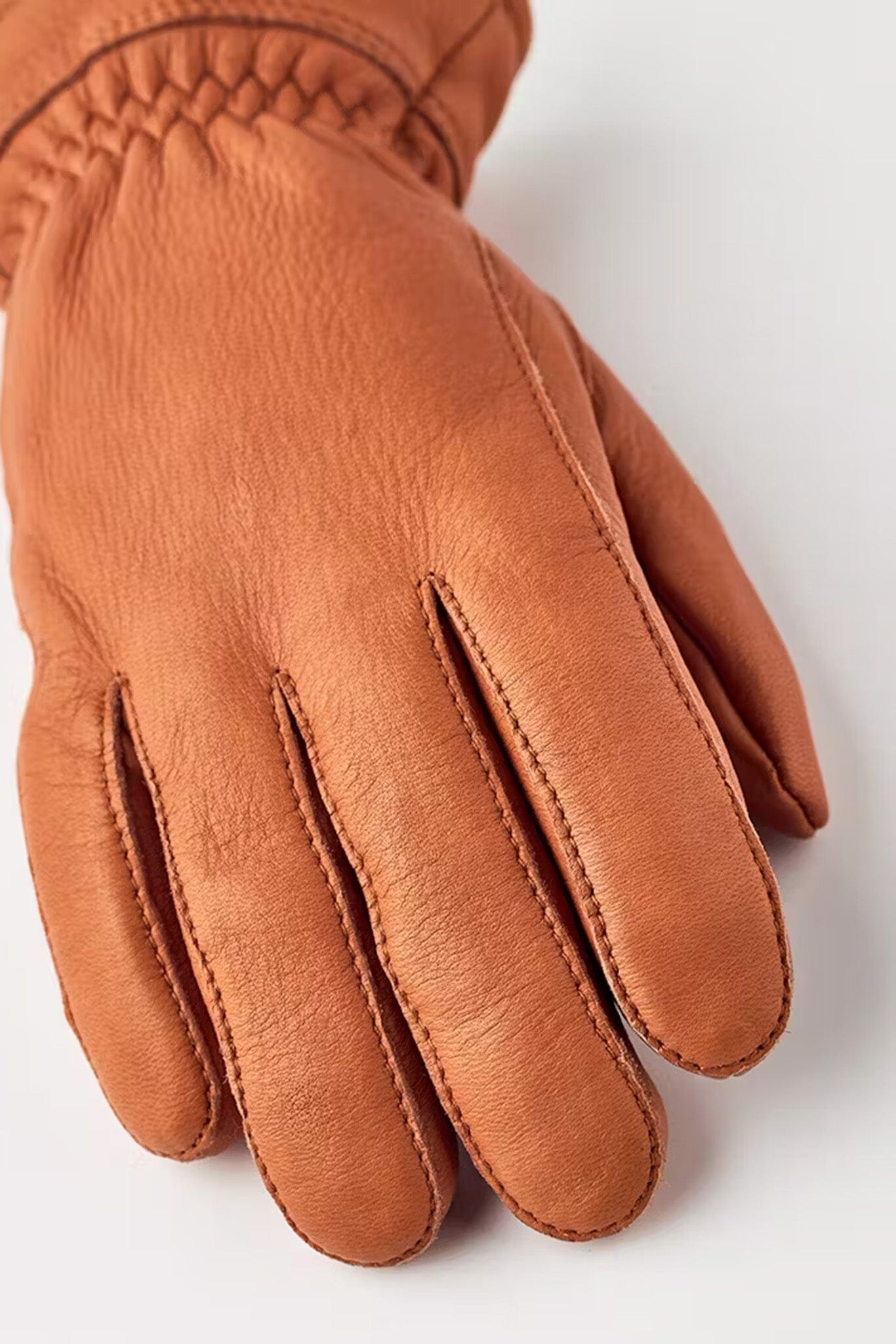 A close up of a women's cork brown insulated winter glove