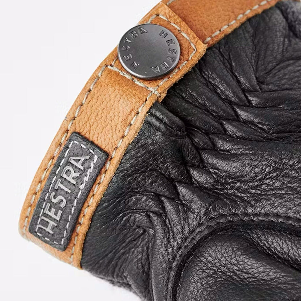 The finishing details of men's tricot deerskin glove with 'HESTRA' branding