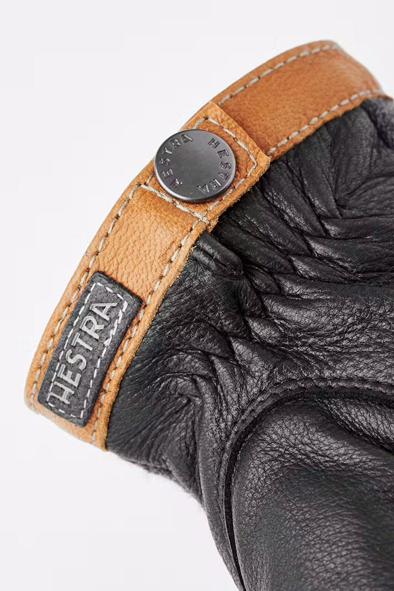 The finishing details of men's tricot deerskin glove with 'HESTRA' branding