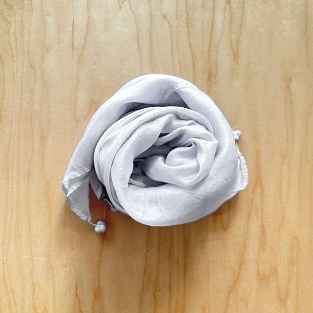 Light grey silver silk scarf with tassel finishes on each corner