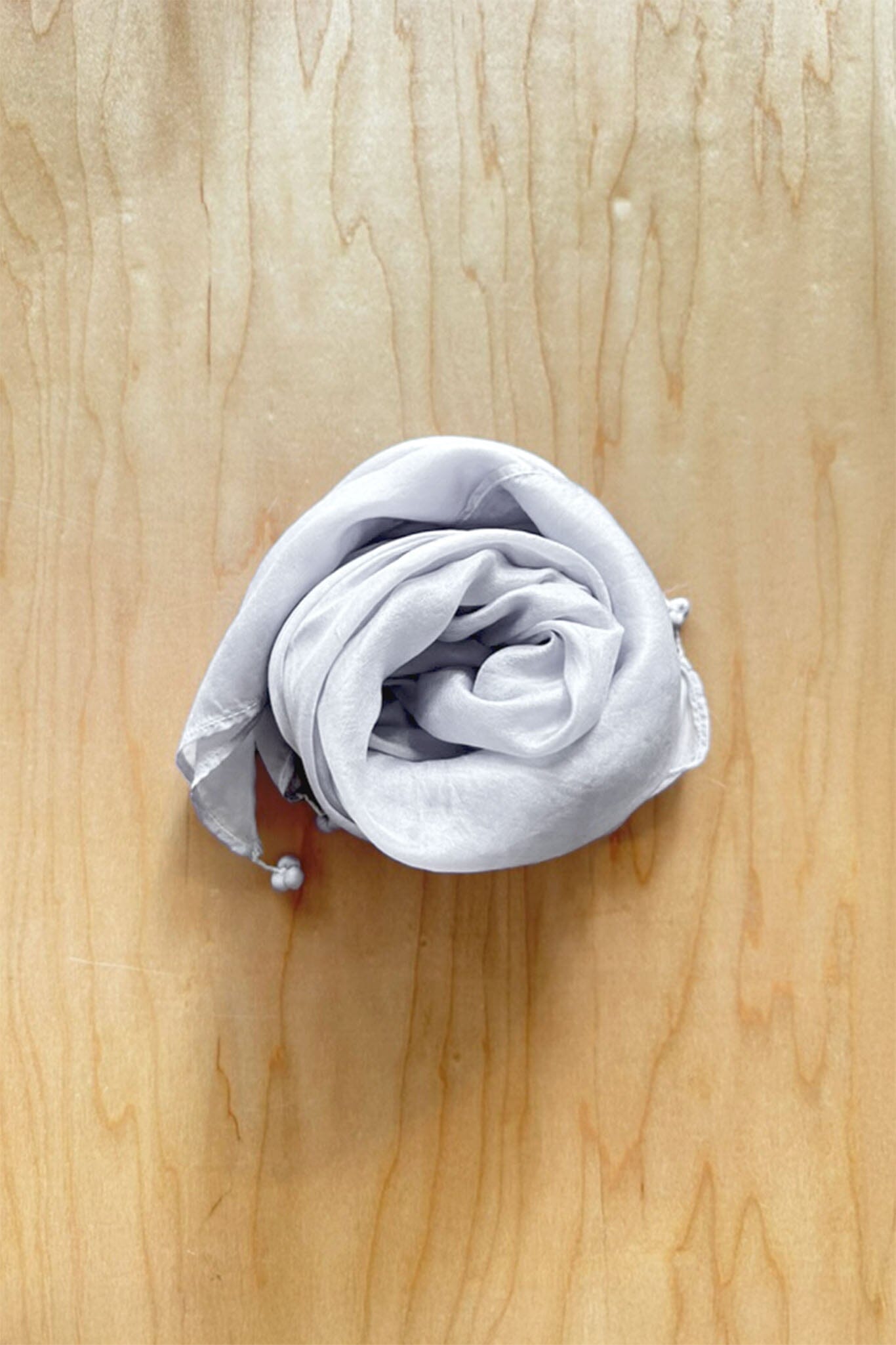 Light grey silver silk scarf with tassel finishes on each corner