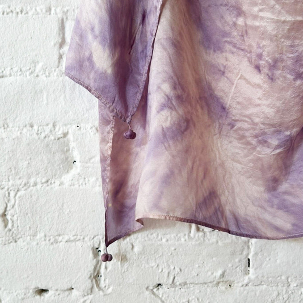 Purple and pink tie dye scarf close up with tassels on each edge