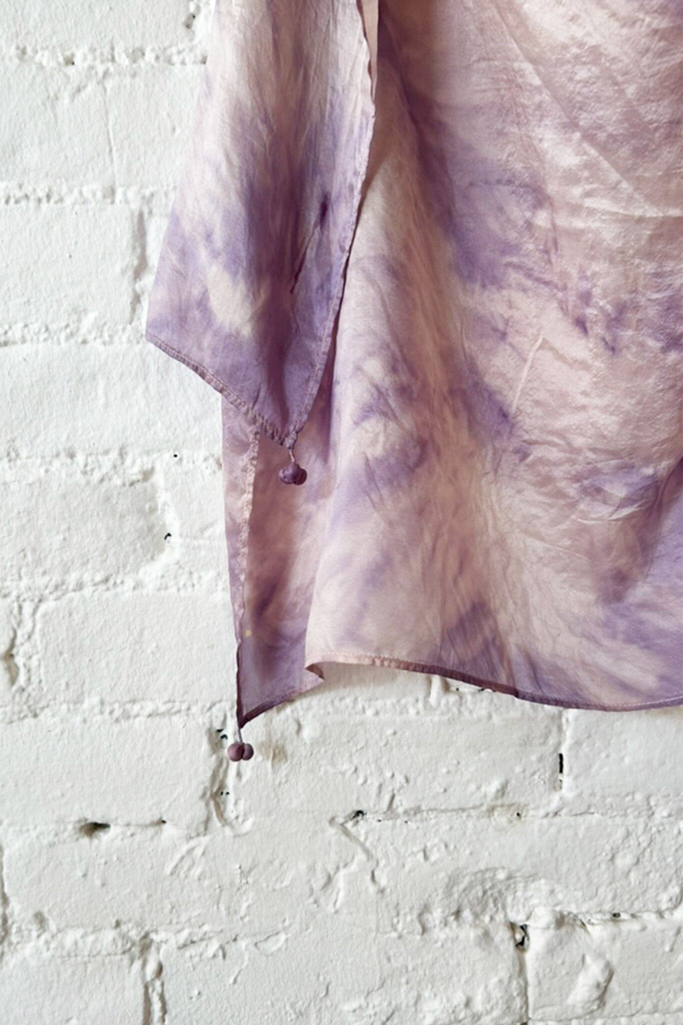 Purple and pink tie dye scarf close up with tassels on each edge