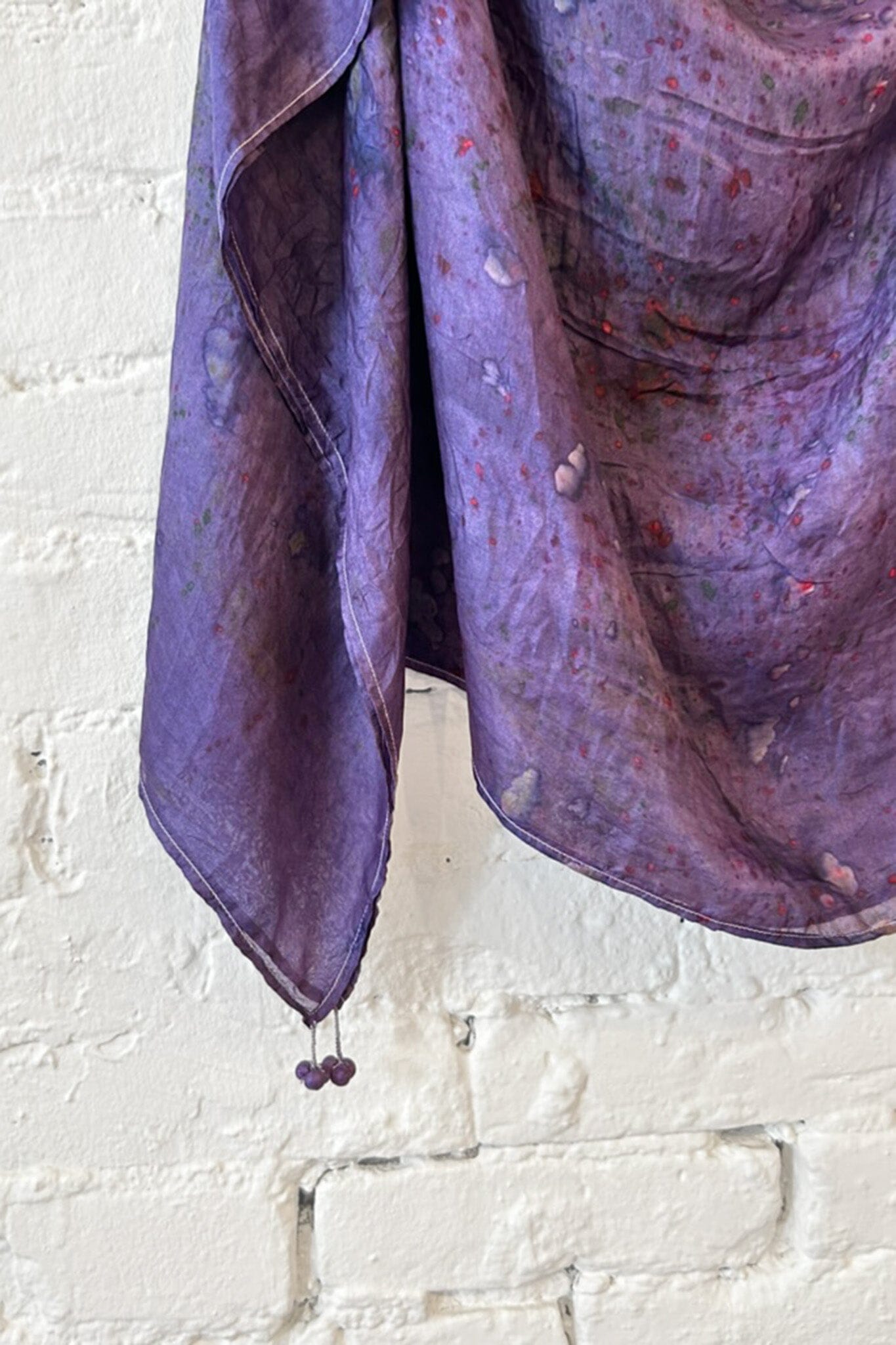 Purple tie dye silk scarf with tassel details on the edge