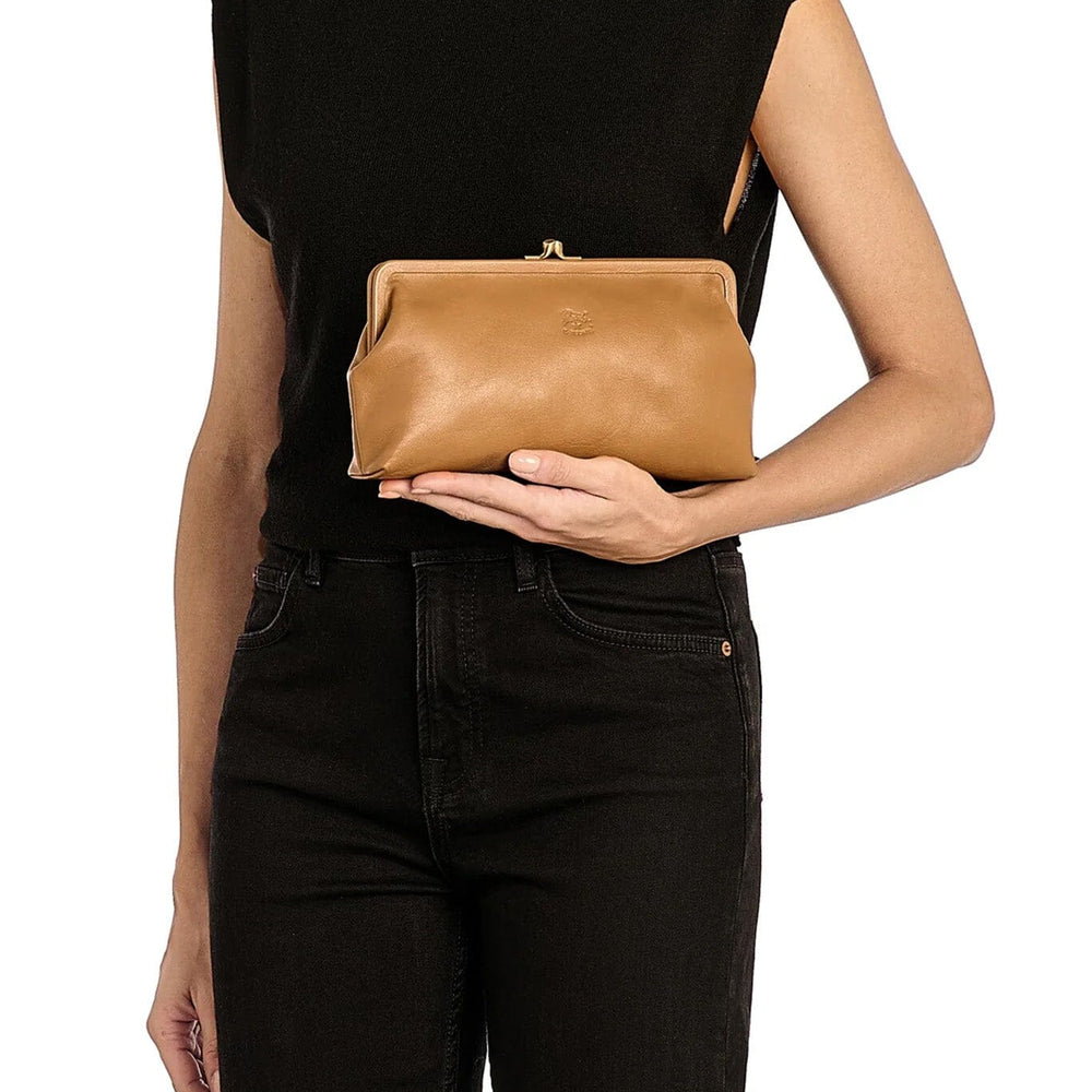
                  
                    Woman holding a light brown leather clutch
                  
                