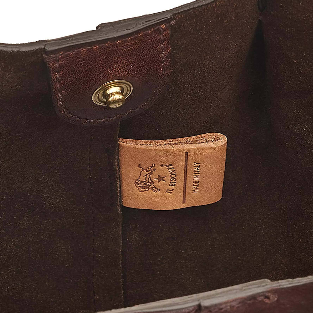 The interior details of a brown coffee colored leather tote bag