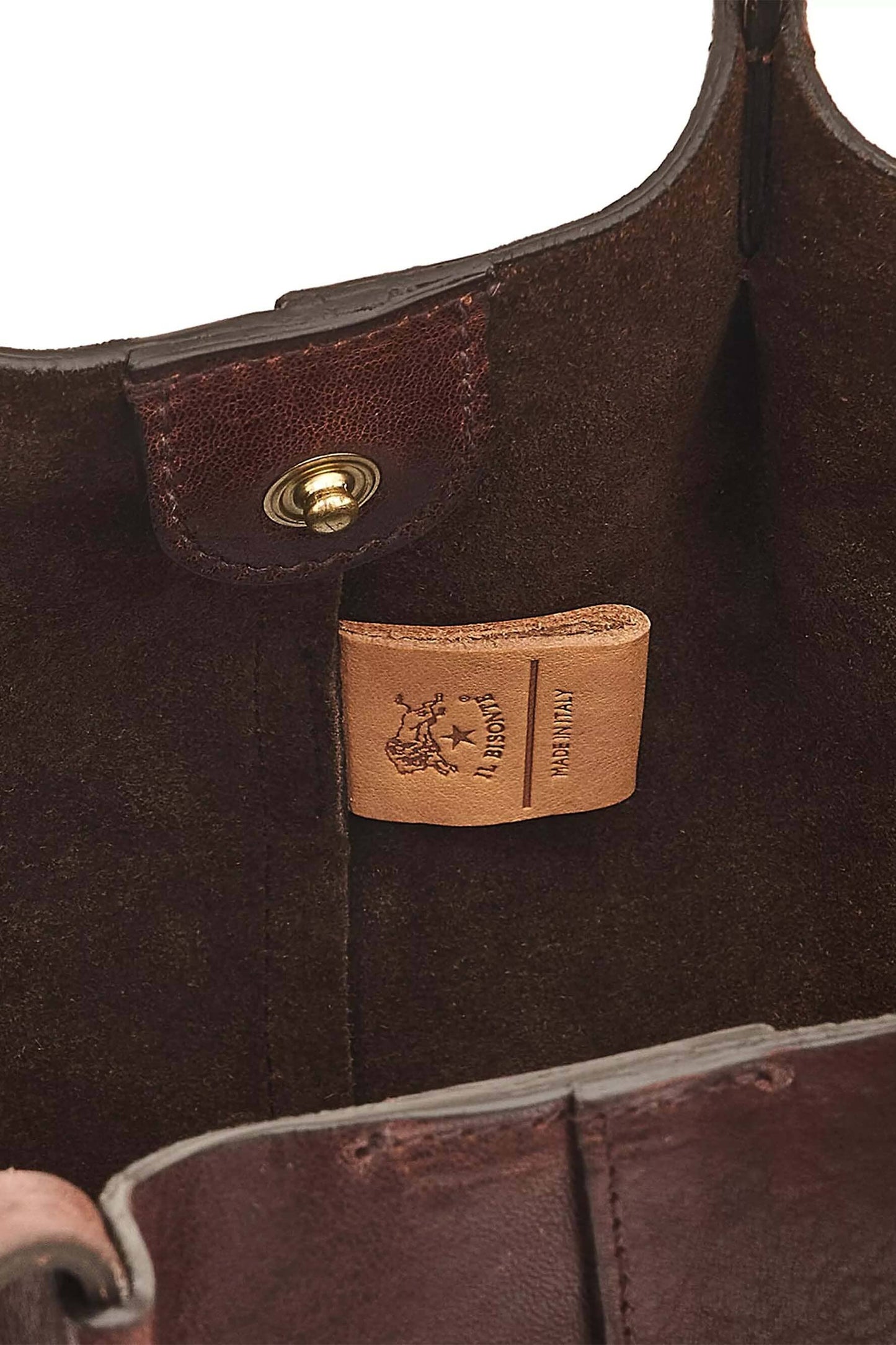The interior details of a brown coffee colored leather tote bag