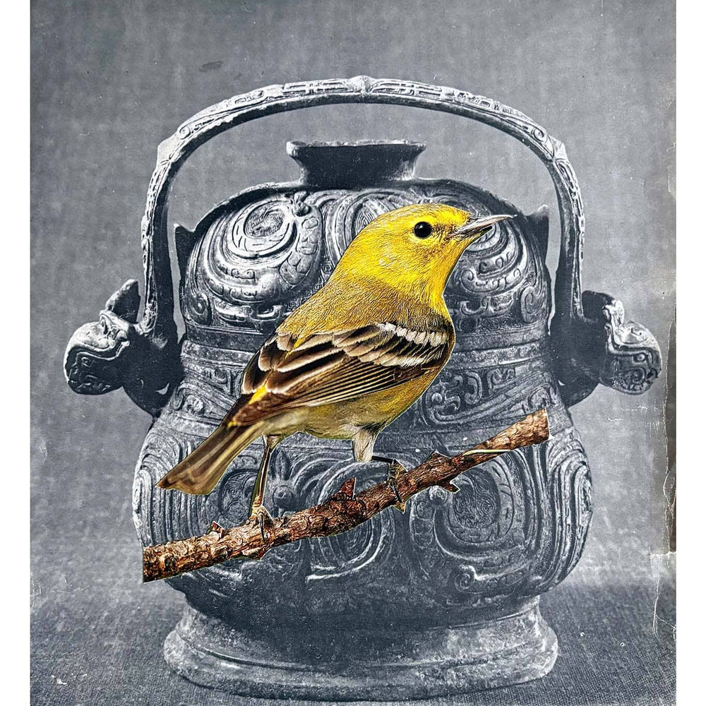 Yellow bird perched on a branch in front of an ornate silver vase on a gray background