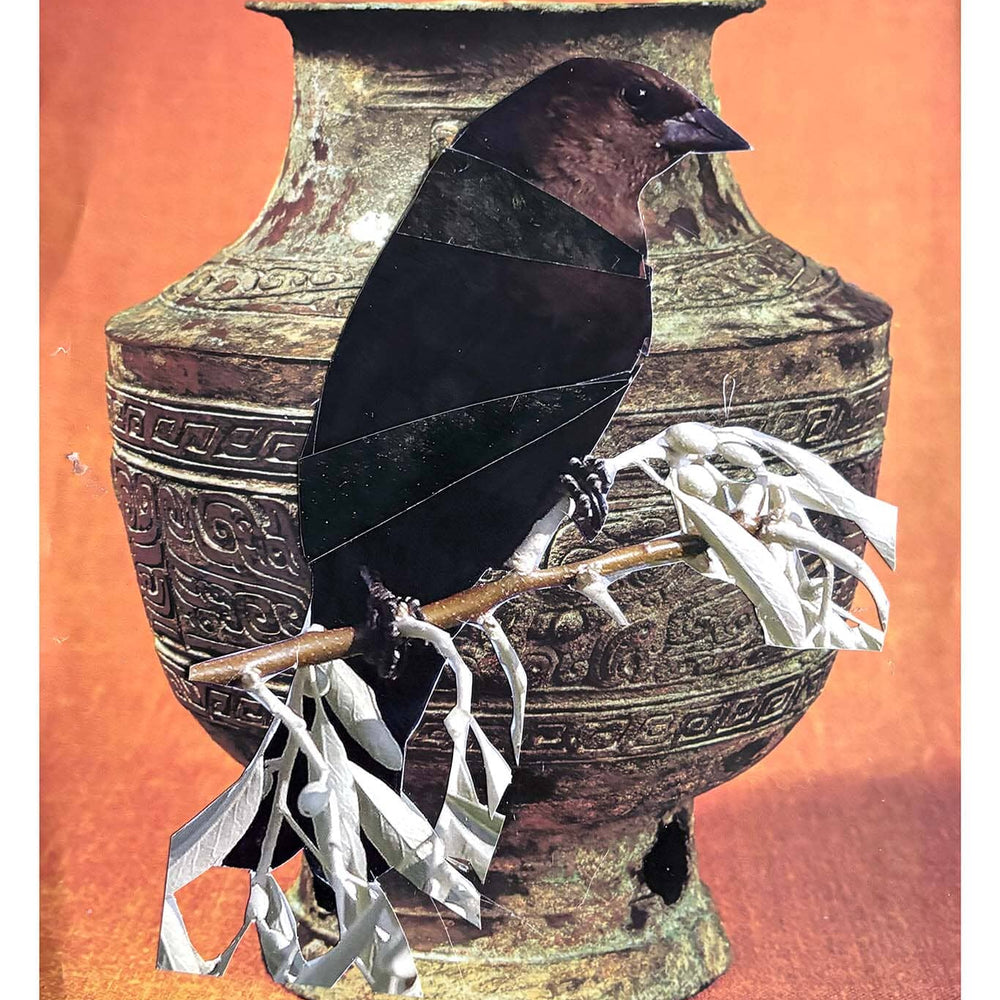 Decorative vase with a bird and branches on an orange background