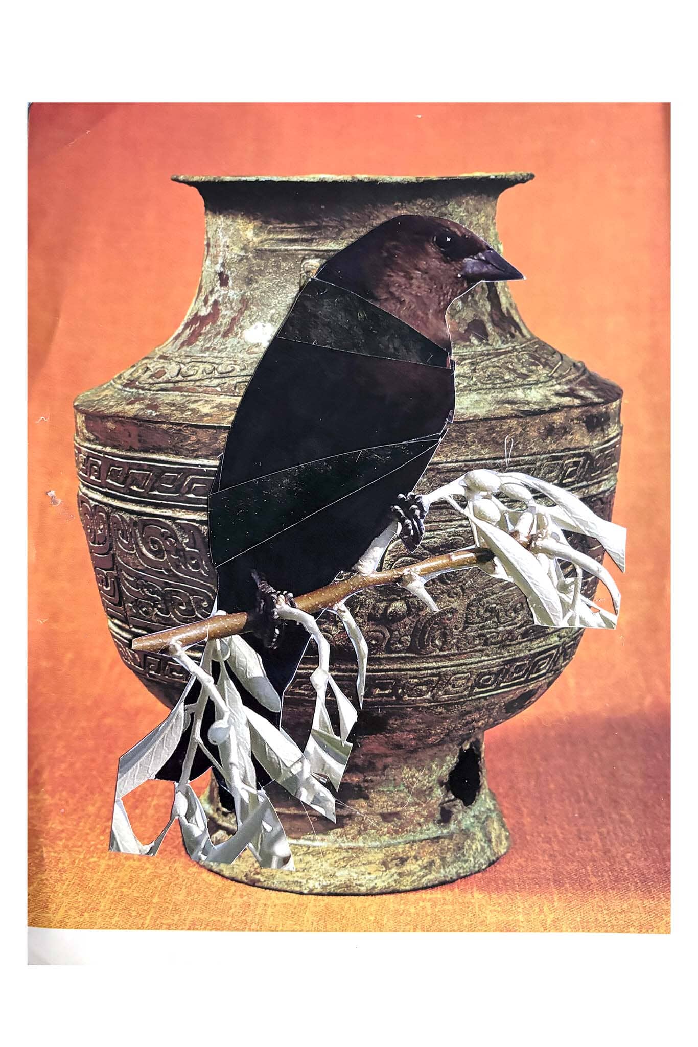 Decorative vase with a bird and branches on an orange background