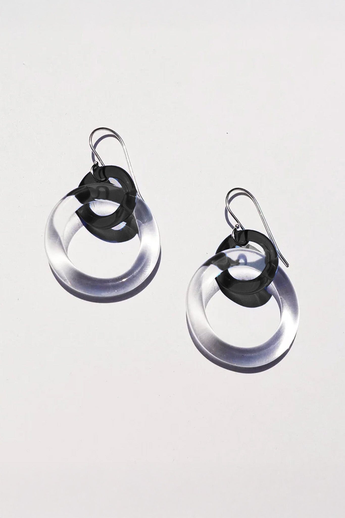Pair of earrings with glass circular earrings on a white background
