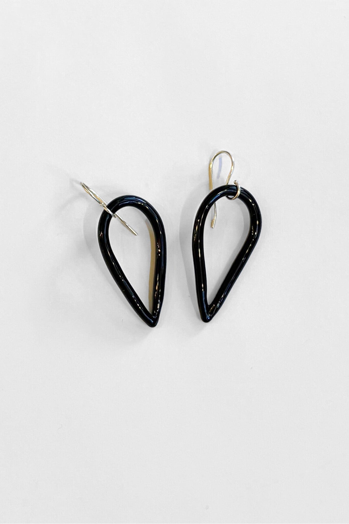 Black tear-shaped earrings with sterling silver ear wire on a white background
